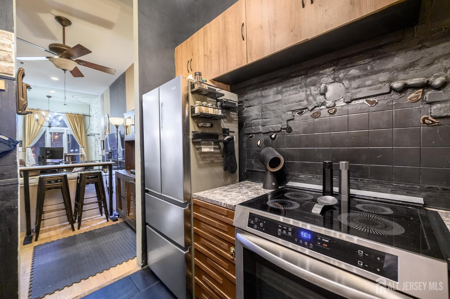 117 Clinton Street, Unit 1F Hoboken, NJ 07030 - Photo 14 of 24 a kitchen with a stove and a refrigerator