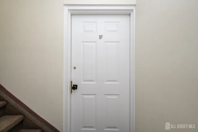 a view of a hallway with a livingroom and furniture