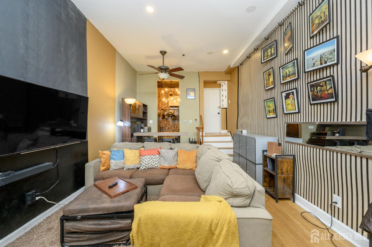 117 Clinton Street, Unit 1F Hoboken, NJ 07030 - Photo 8 of 24 a living room with furniture and a flat screen tv