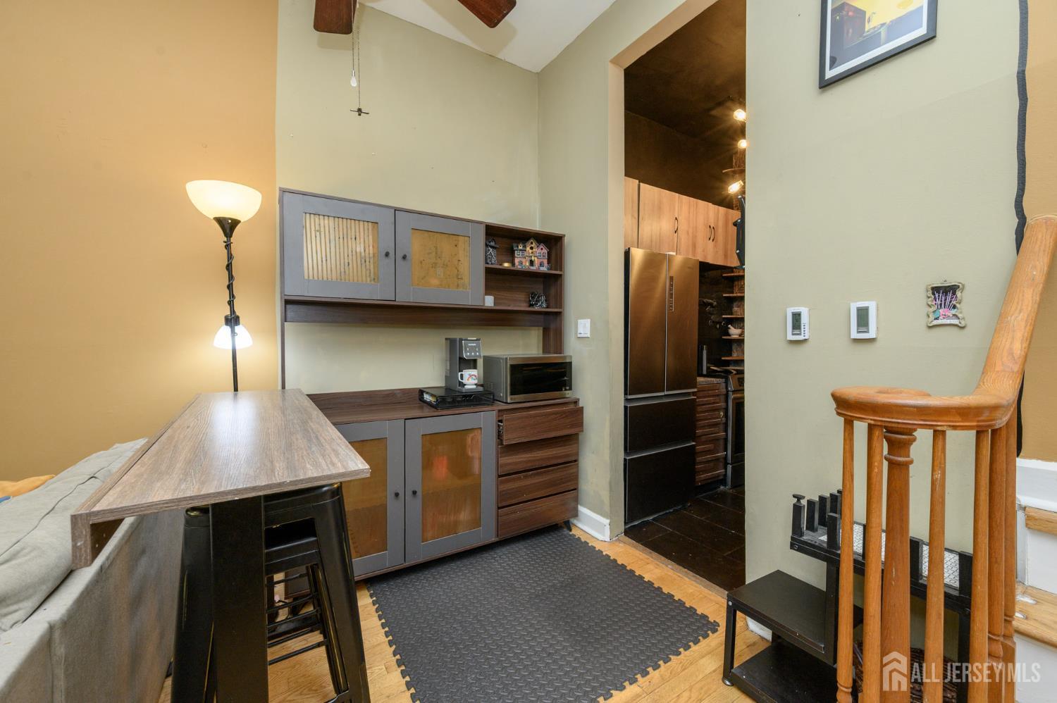 117 Clinton Street, Unit 1F Hoboken, NJ 07030 - Photo 10 of 24 a kitchen with stainless steel appliances granite countertop a refrigerator a stove and a sink with wooden floor