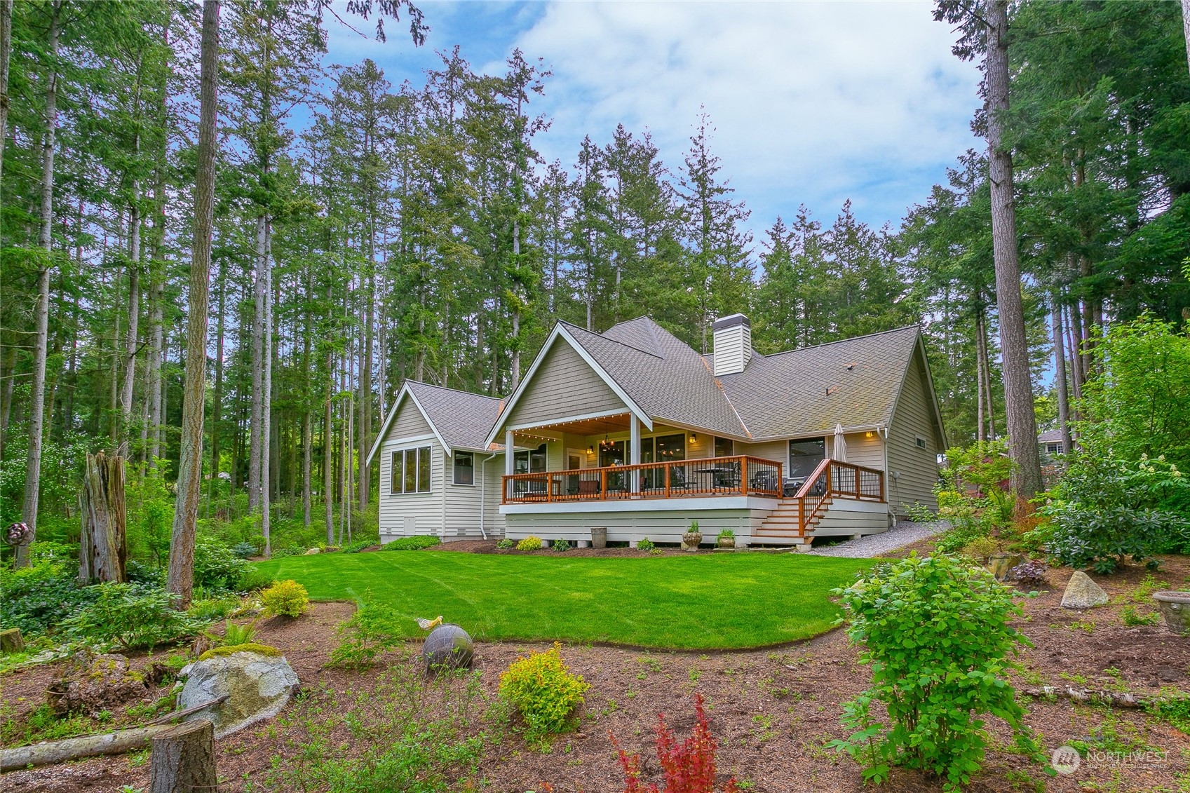 5487 Canvasback Road Blaine, WA 98230 - Photo 1 of 40 a view of a house with a big yard and large trees