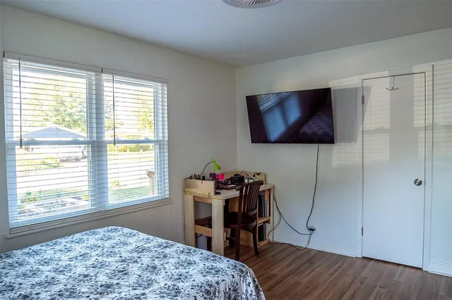 a bedroom with a bed and a window