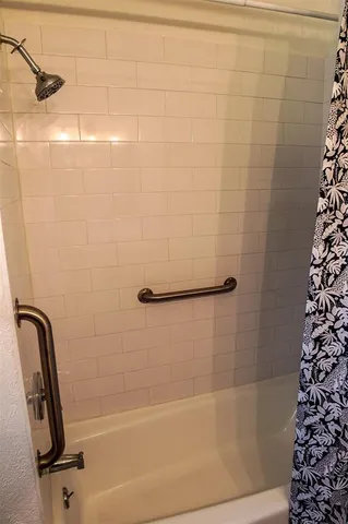 a bathroom with a shower and a sink