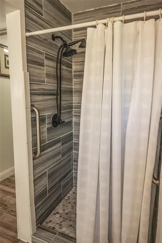 a bathroom with a shower and a window