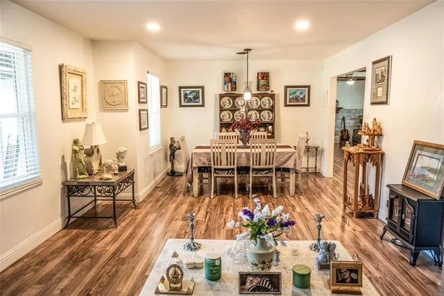 a living room with furniture a flat screen tv and a floor to ceiling window