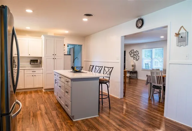 a kitchen with sink cabinets and wooden floor