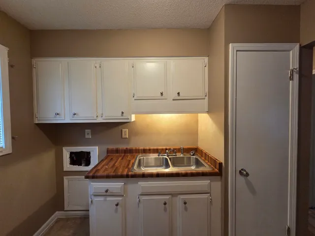 a kitchen with a sink and cabinets