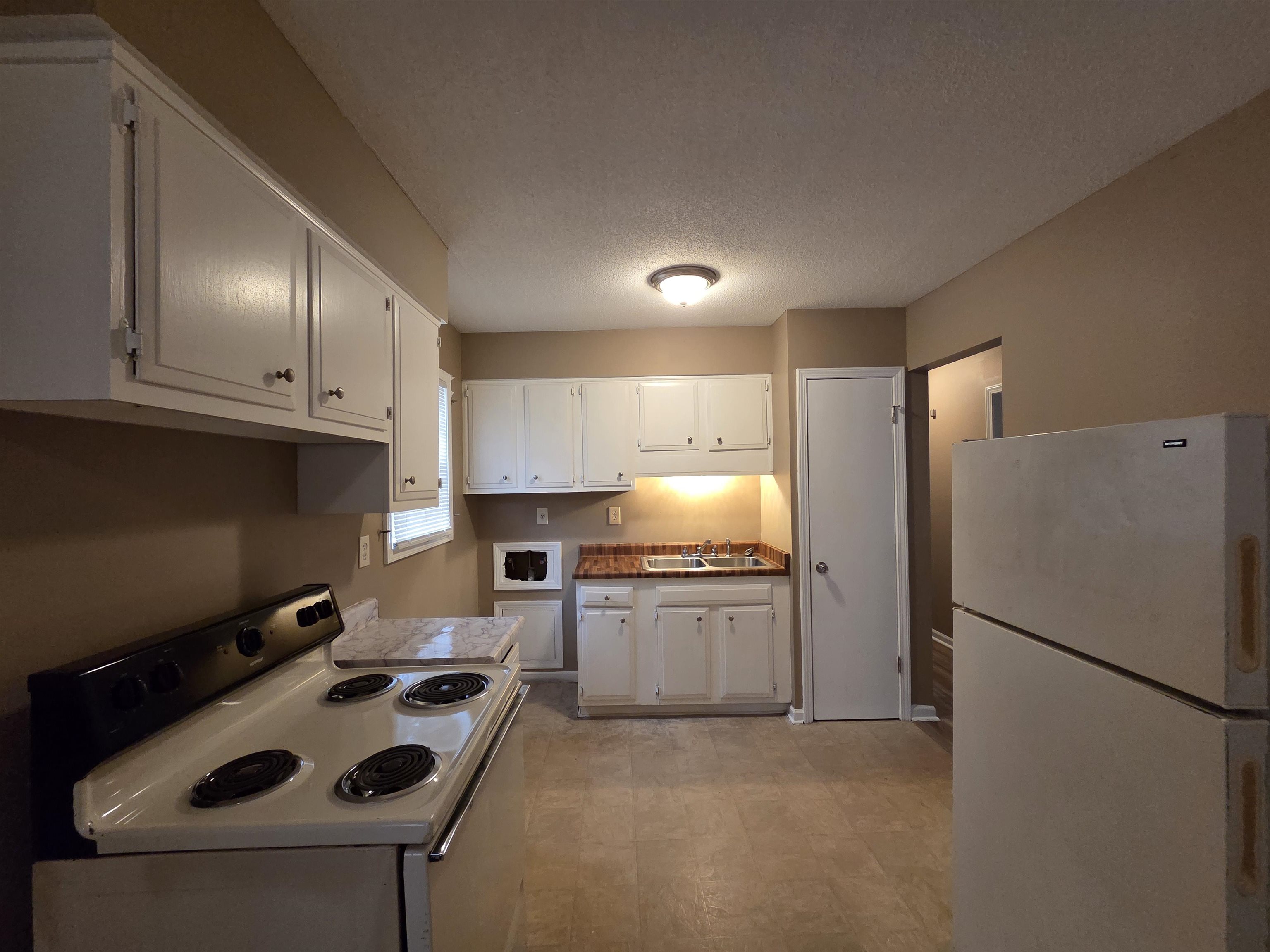 2192 Lisa Avenue Memphis, TN 38127 - Photo 10 of 21 a kitchen with a sink a refrigerator and cabinets