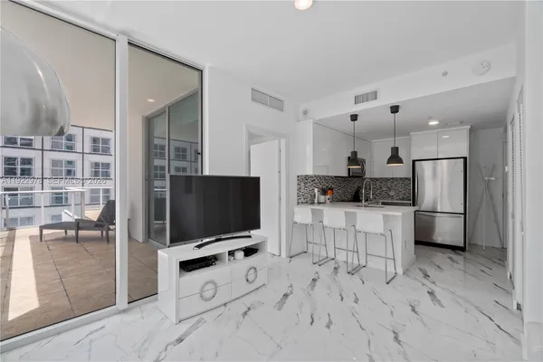 a kitchen with stainless steel appliances a refrigerator and a stove top oven