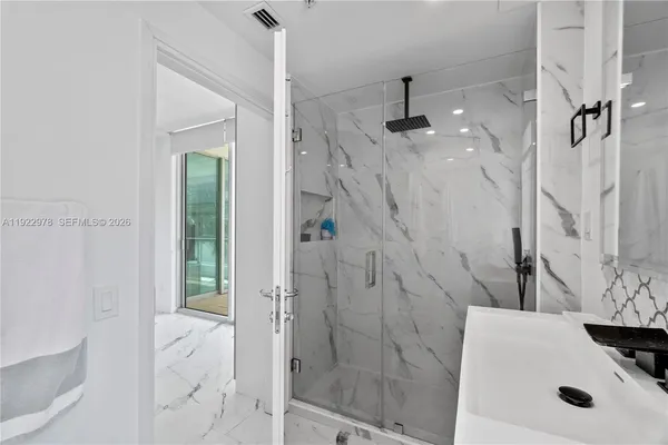 a bathroom with a sink and shower