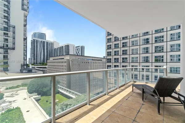 a view of a balcony with a couch and table
