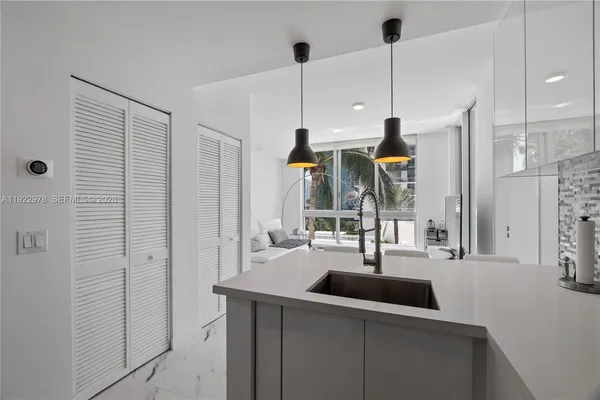 a kitchen with counter top space and sink