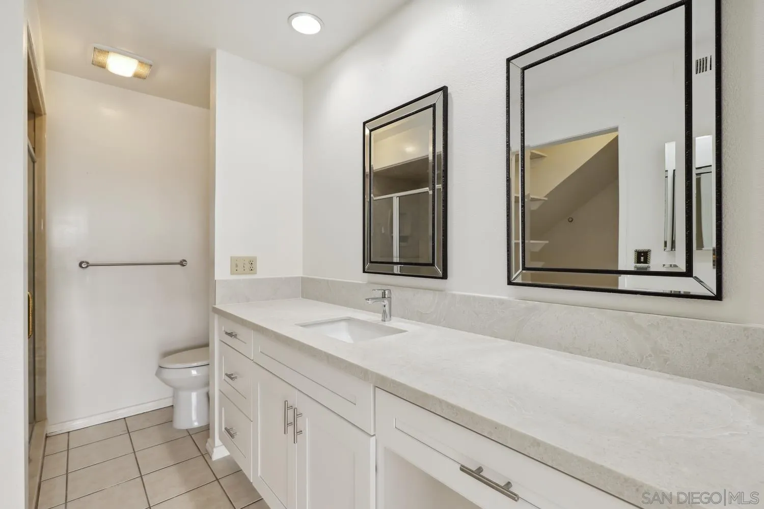1957 Outrigger Way Oceanside, CA 92054 - Photo 16 of 32 a bathroom with a toilet sink and mirror