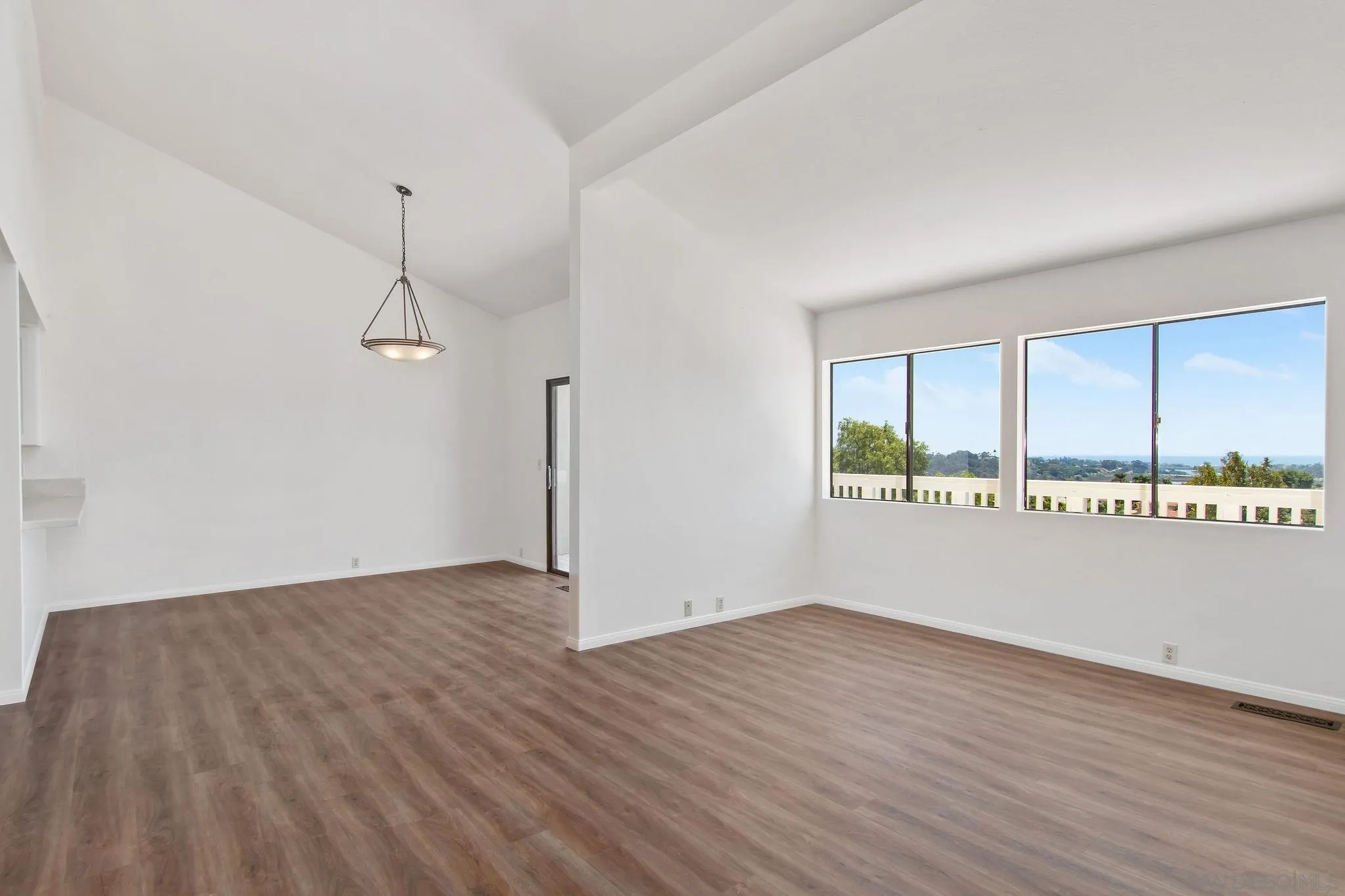 1957 Outrigger Way Oceanside, CA 92054 - Photo 10 of 32 an empty room with wooden floor and windows