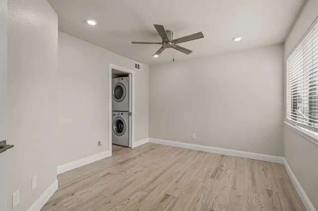 a view of a livingroom with a ceiling fan and window