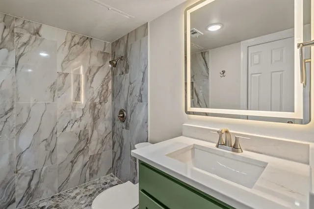 a bathroom with a toilet and shower