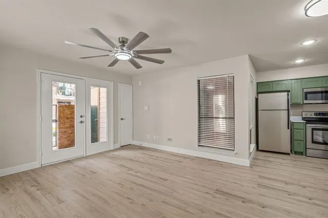 a kitchen with a refrigerator and a stove top oven
