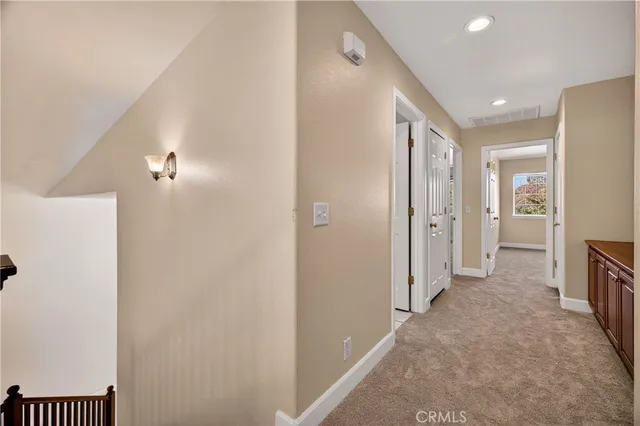 a view of a hallway with closet and livingroom
