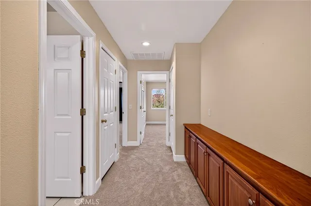 a view of hallway with wooden floor