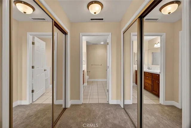 a view of a hallway with wooden floor and living room