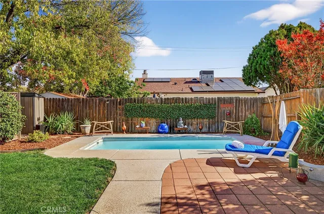 a view of a chairs and tables in the back yard of the house