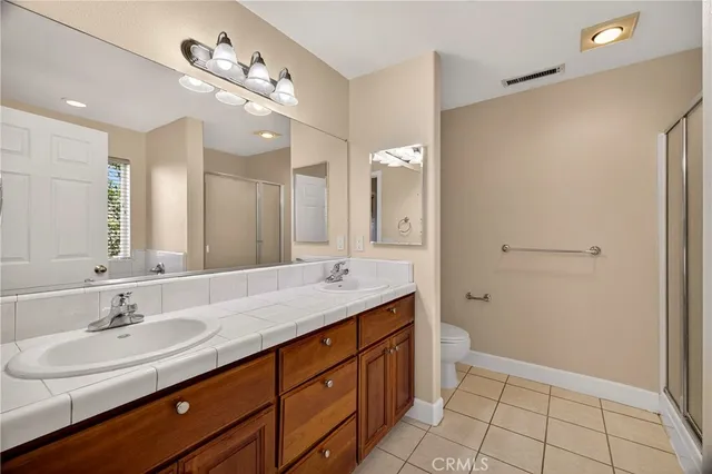 a bathroom with a double vanity sink mirror and double