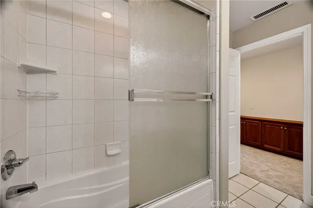 a bathroom with a shower and a tub