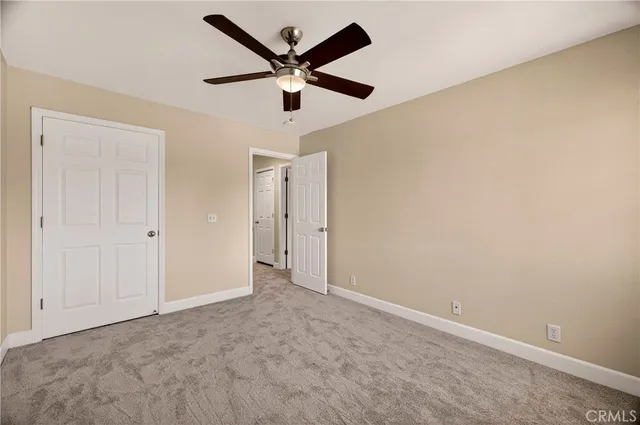 an empty room with a ceiling fan and a ceiling fan