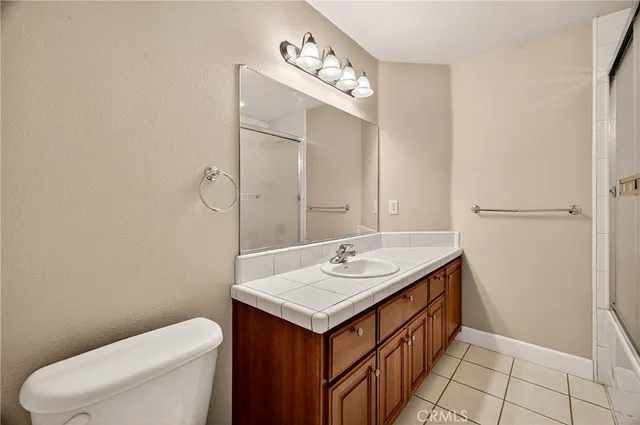 a bathroom with a sink toilet and mirror