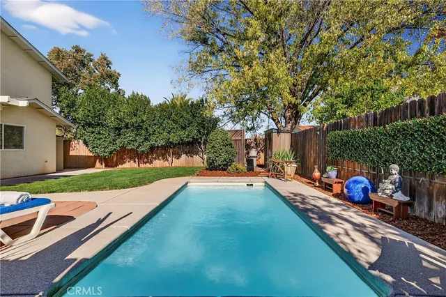 a view of a backyard with swimming pool