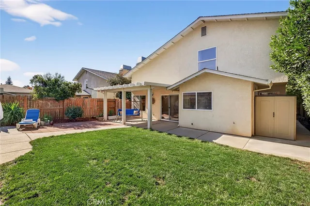 a view of a house with sitting area and garden