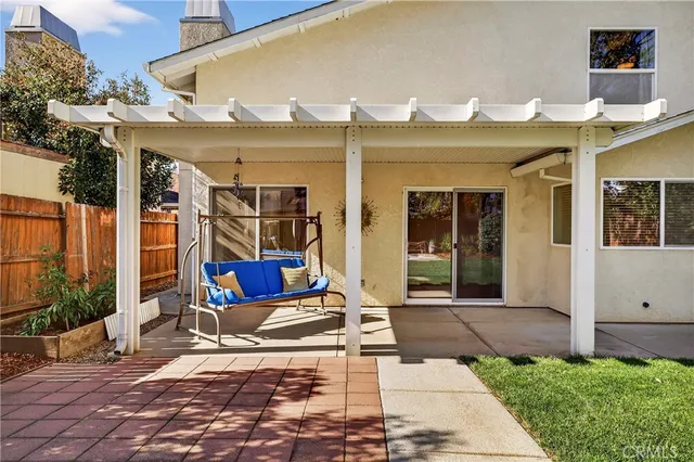 a view of a patio with table and chairs near a yard