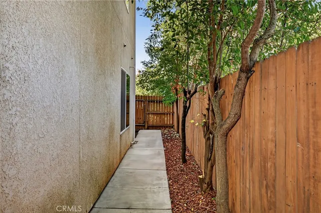 a view of a pathway with a wooden fence