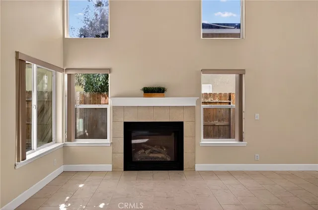 a living room with a fireplace and a window