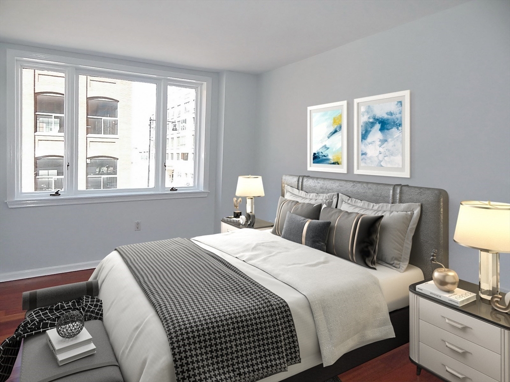 10 Rogers Street, Unit 415 Cambridge, MA 02142 - Photo 2 of 10 a bedroom with a bed and a lamp on dresser