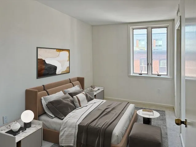 a bedroom with a bed and window