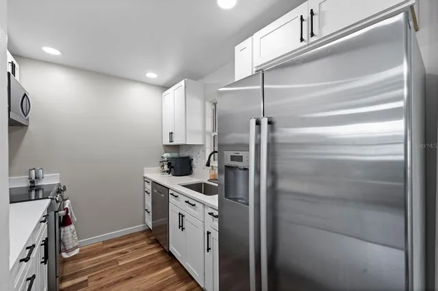 a kitchen with cabinets and stainless steel appliances