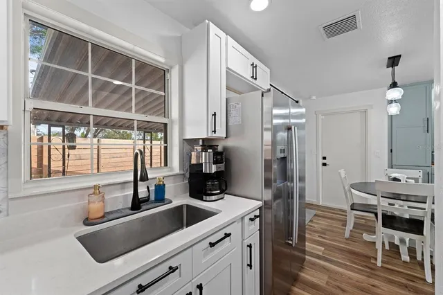a kitchen with a sink stove and cabinets