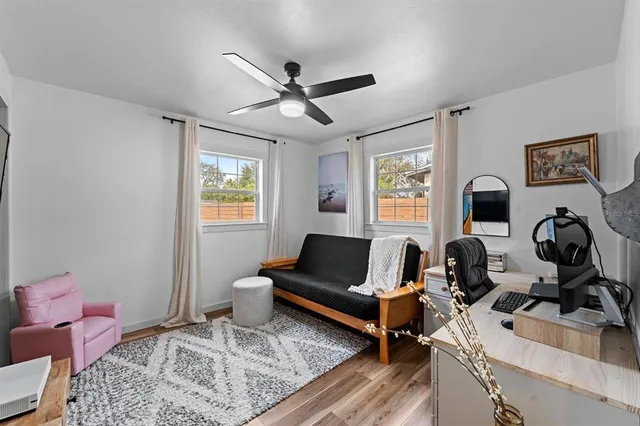 a living room with furniture and wooden floor