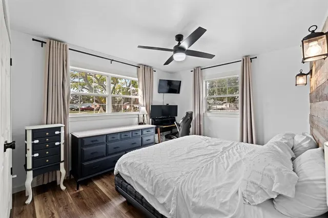 a bedroom with a bed and a large window