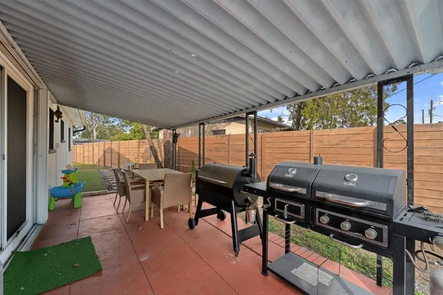 a view of a chairs and table in patio