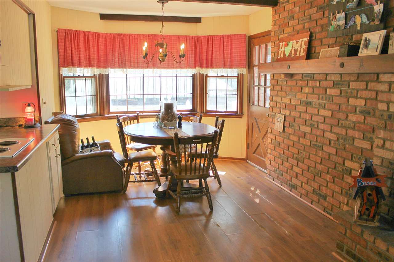 1506 Warren Road Rockford, IL 61108 - Photo 14 of 25 a view of a dining room with furniture and wooden floor