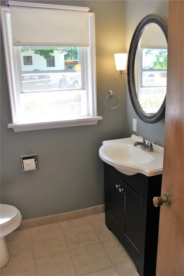 1506 Warren Road Rockford, IL 61108 - Photo 17 of 25 a bathroom with a sink a toilet and a mirror