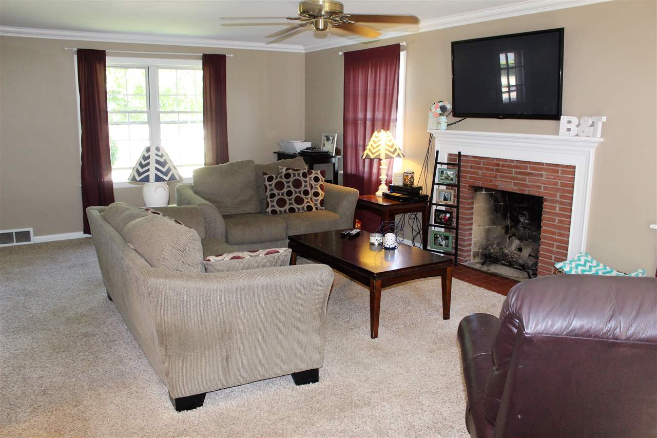 1506 Warren Road Rockford, IL 61108 - Photo 6 of 25 a living room with furniture and a fireplace