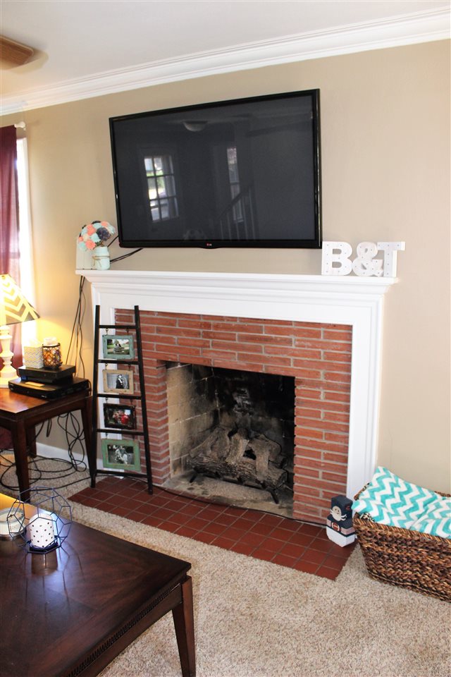 1506 Warren Road Rockford, IL 61108 - Photo 7 of 25 a living room with furniture and a fireplace