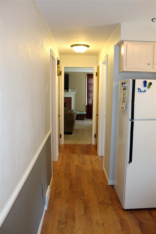 1506 Warren Road Rockford, IL 61108 - Photo 10 of 25 a view of a hallway with wooden floor and staircase