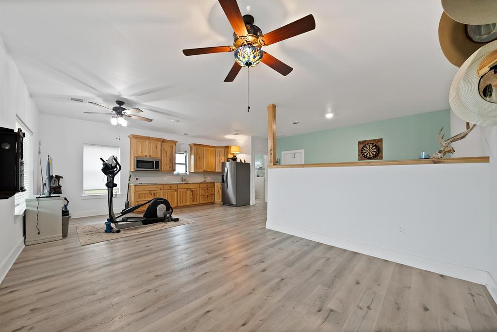 100 Shadle Ridge Court Poolville, TX 76487 - Photo 27 of 40 Open concept room featuring light wood-finish flooring