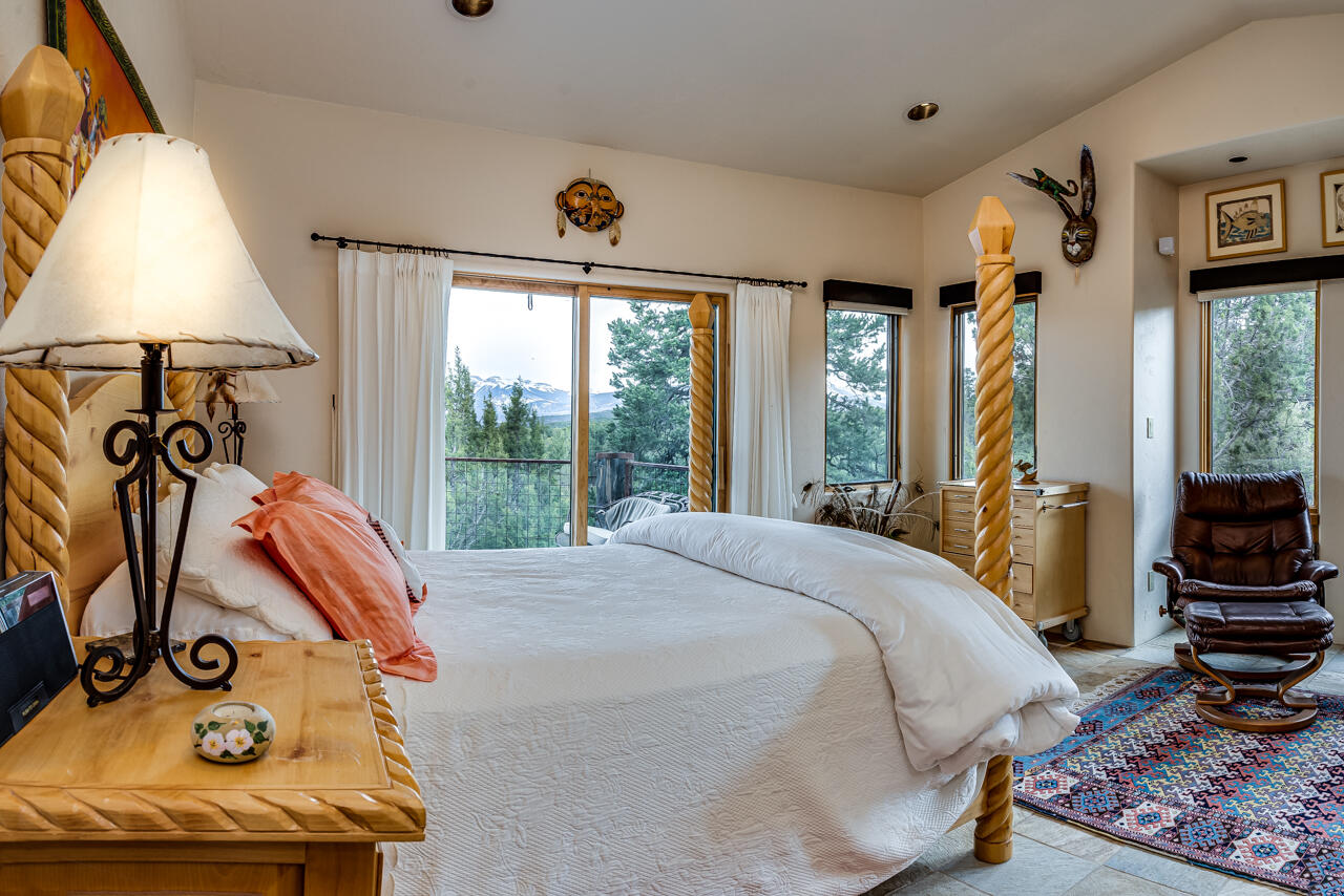 499 Waterview Lane Ridgway, CO 81432 - Photo 14 of 43 a bed sitting in a bedroom next to a window