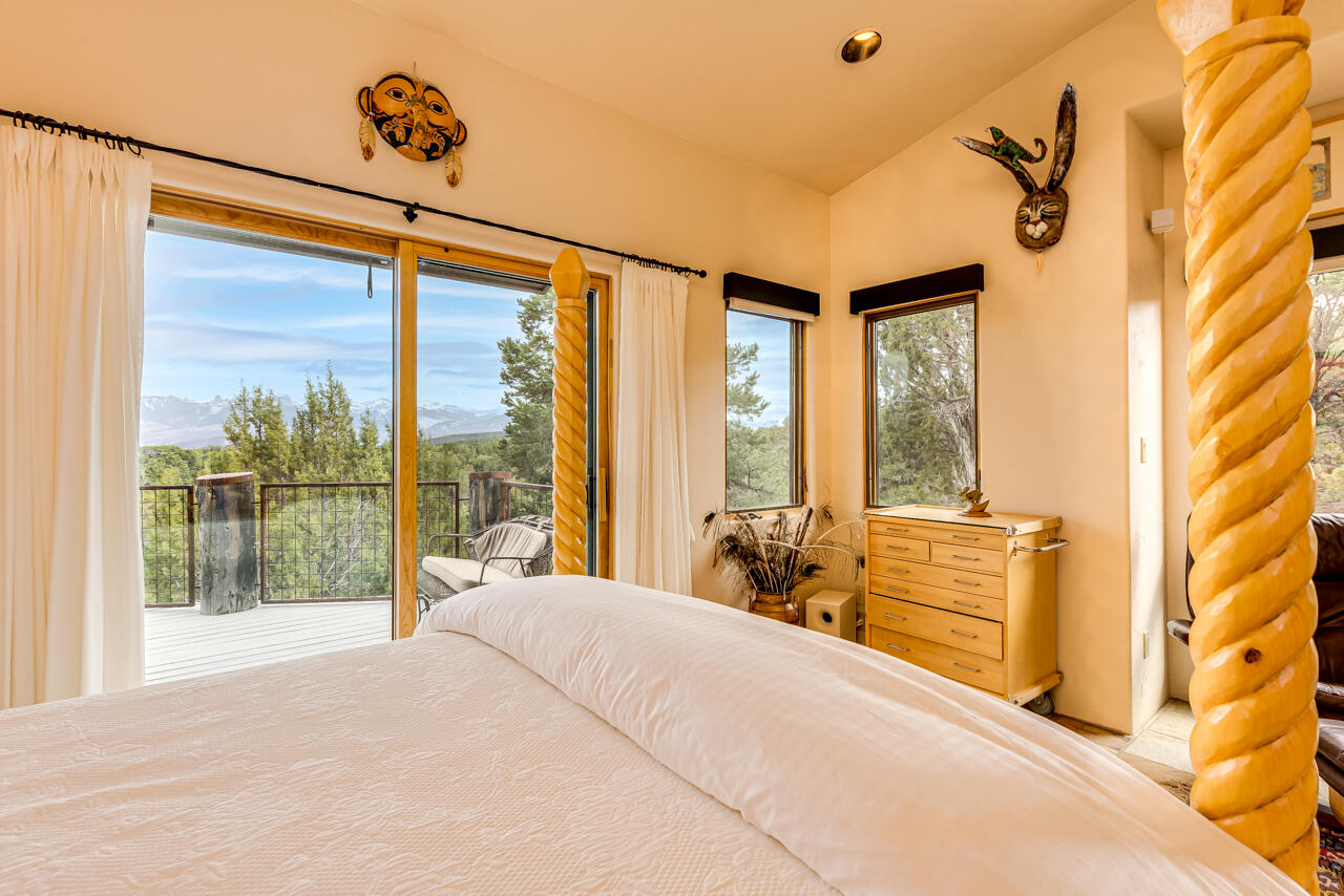 499 Waterview Lane Ridgway, CO 81432 - Photo 15 of 43 a bedroom with a large bed and a large window