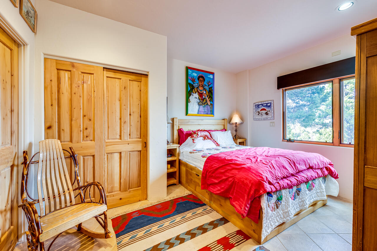 499 Waterview Lane Ridgway, CO 81432 - Photo 24 of 43 a bedroom with a bed and a painting on the wall